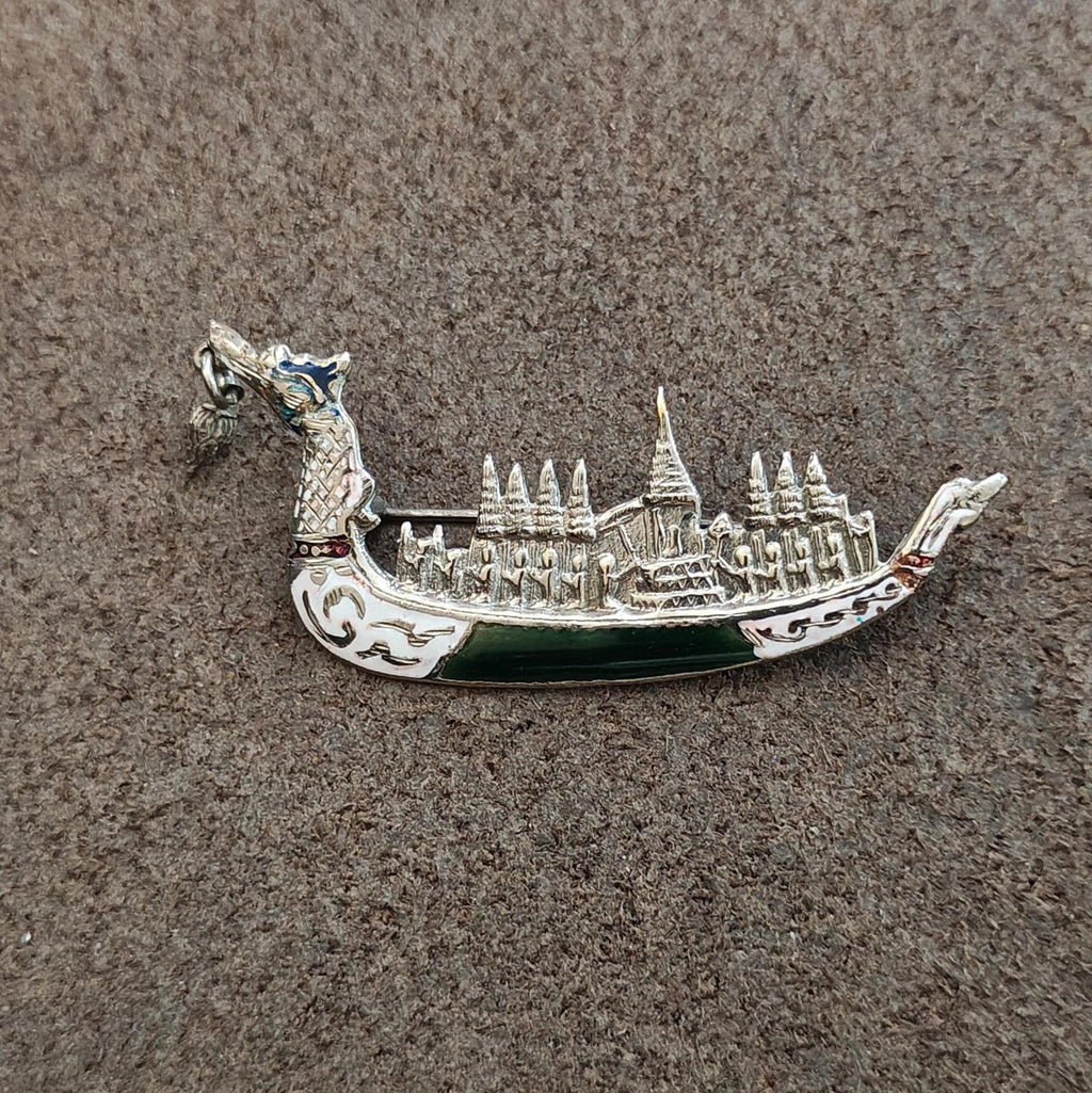 Sterling silver dragon brooch showing detailed temple skyline and dark green enamel base