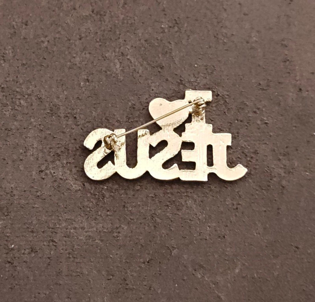 Gold-tone script brooch pin with butterfly clasp backing, shown front