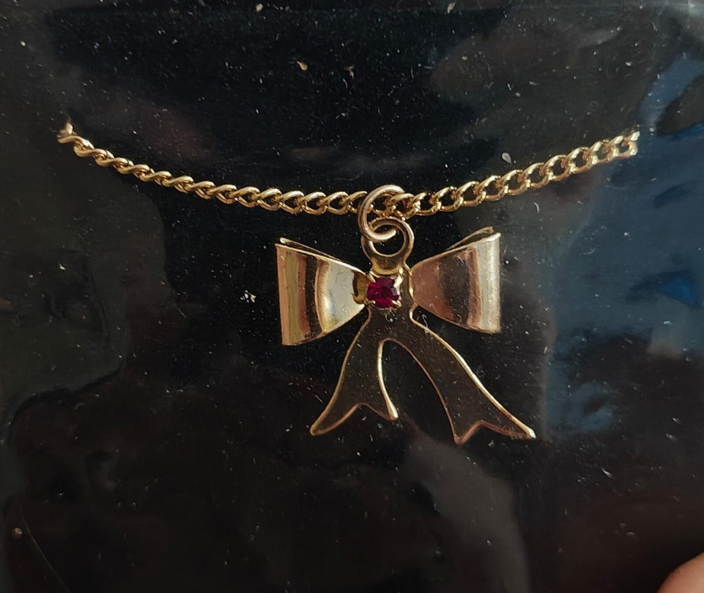 1980s 14k Gold Tone Bow Pendant Necklace With Vibrant Red Stone