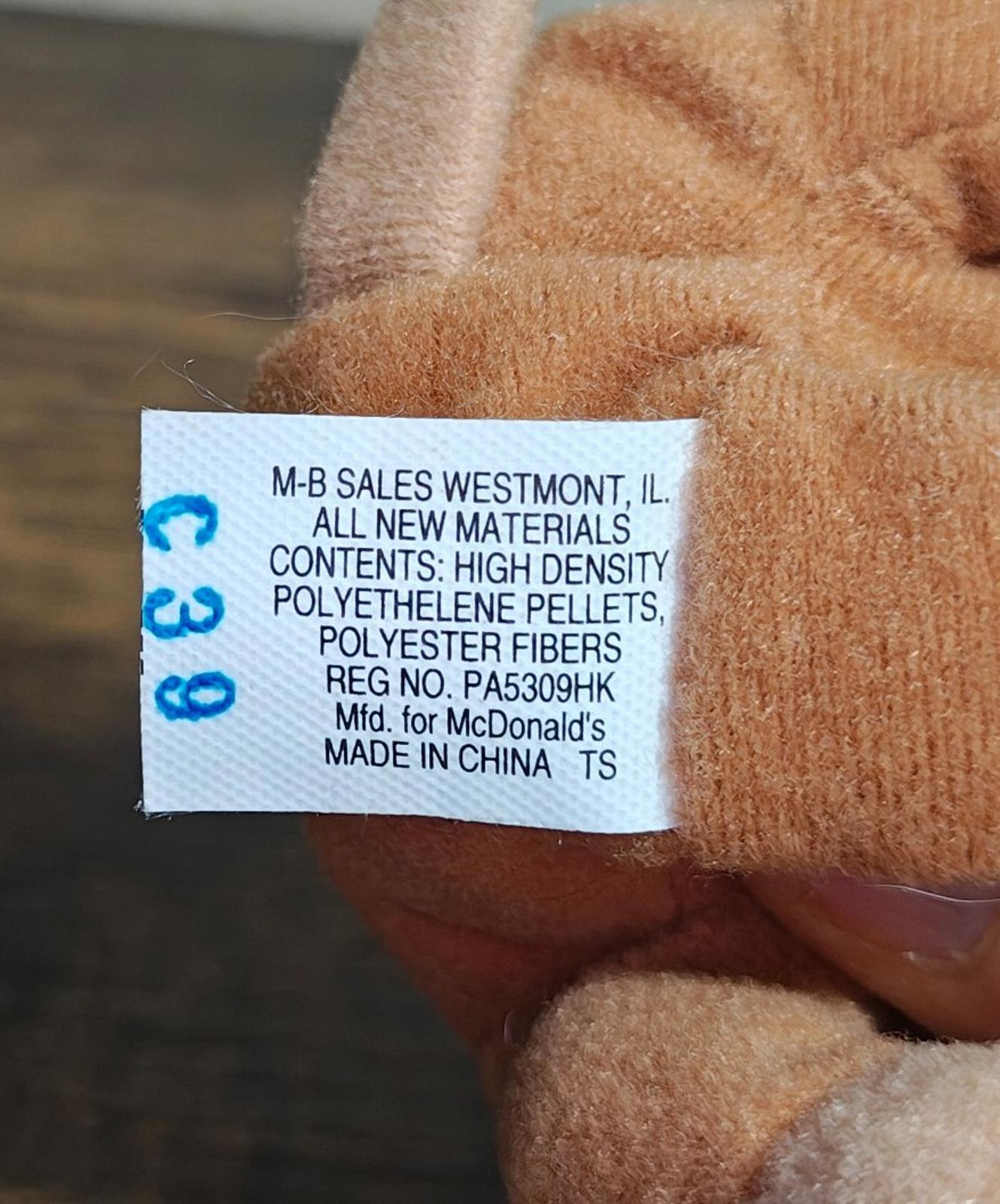 Close-up of plush monkey fabric with white care label text