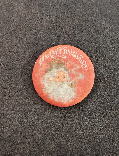 Orange round Santa Christmas pin button with “Merry Christmas” text and Santa artwork