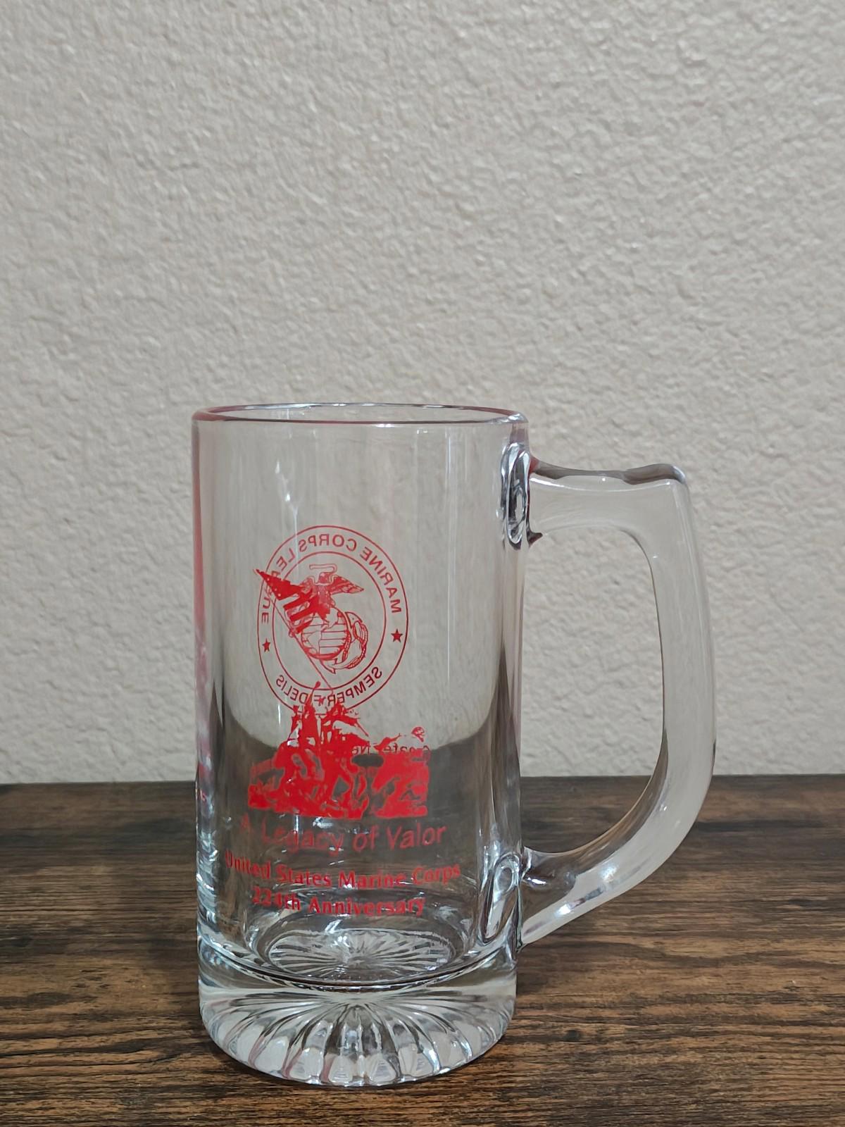 Clear glass beer mug with handle and red circular logo, 'Legacy of Valor' text