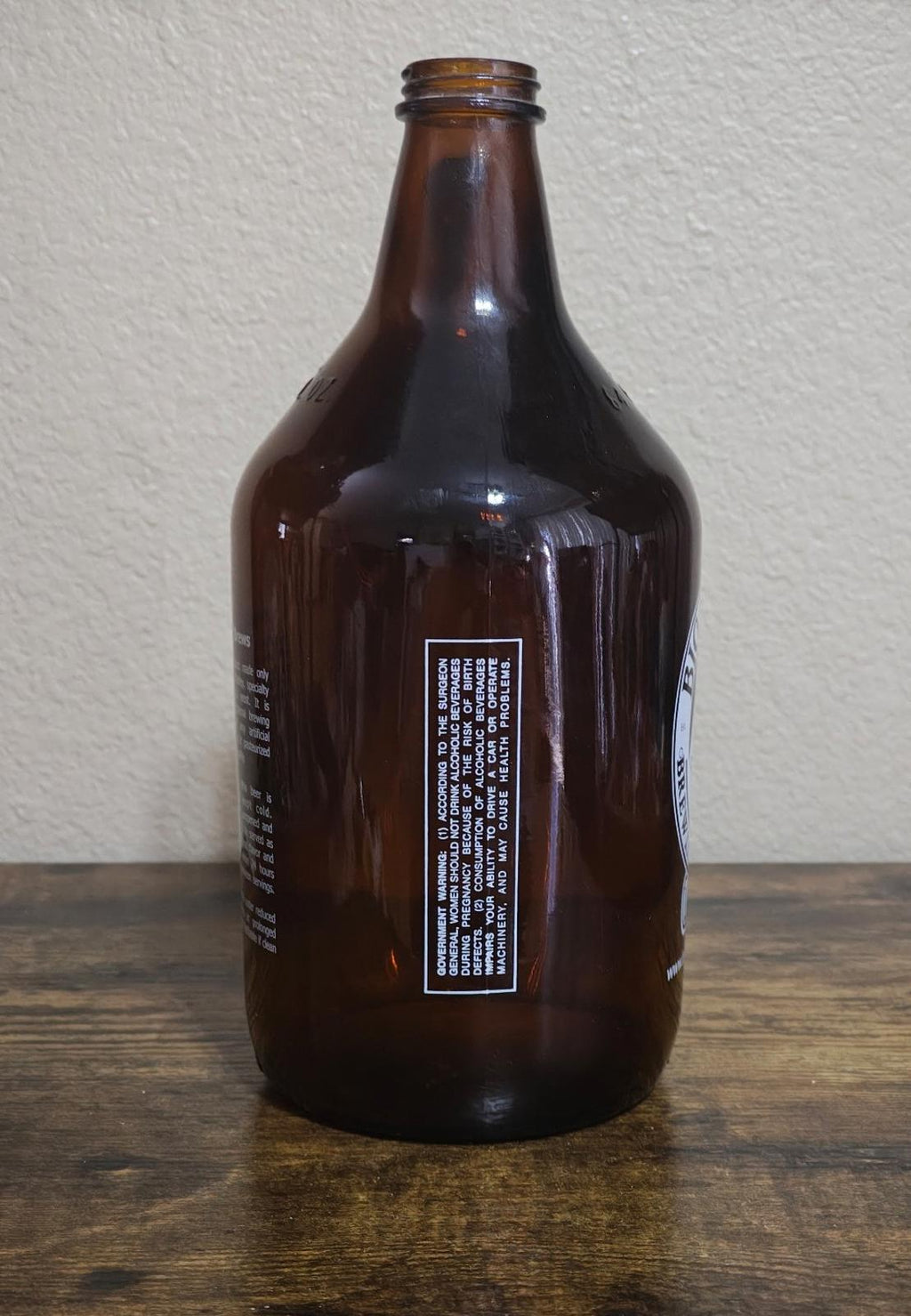 Amber glass jug back with white label and barcode sticker