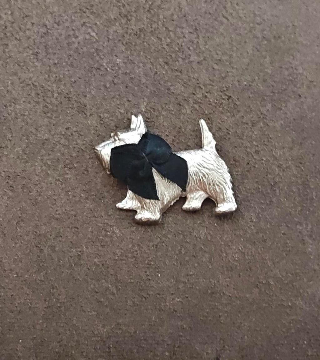 Silver-tone terrier brooch with black bow, full dog figure