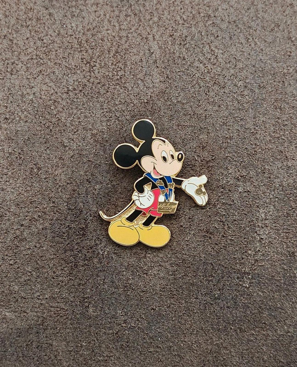 Gold-tone enamel Mickey Mouse trading pin, centered figure with blue vest and yellow shoes