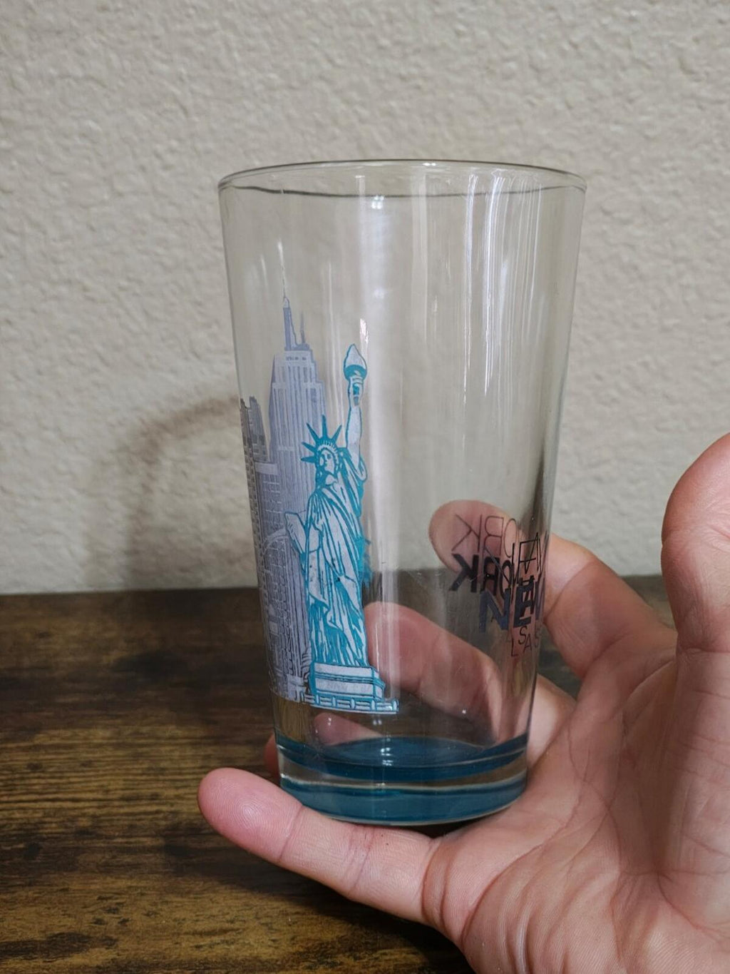 Clear pint glass with blue Statue Liberty-style skyline print, blue-tinted bottom