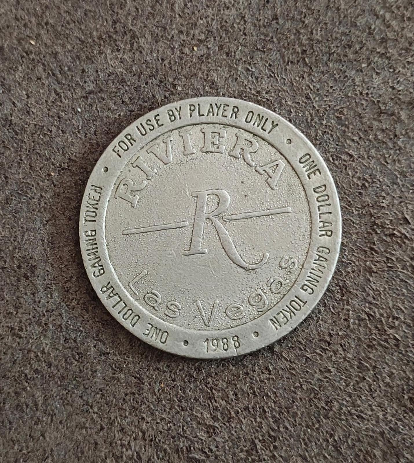 Silver one-dollar gaming token with Riviera logo and 1988 date on rim