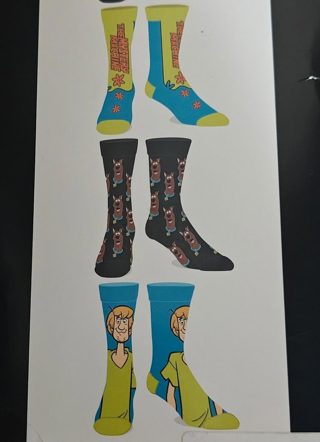 Men's casual crew socks 6-pack display showing four sock pairs with character art.