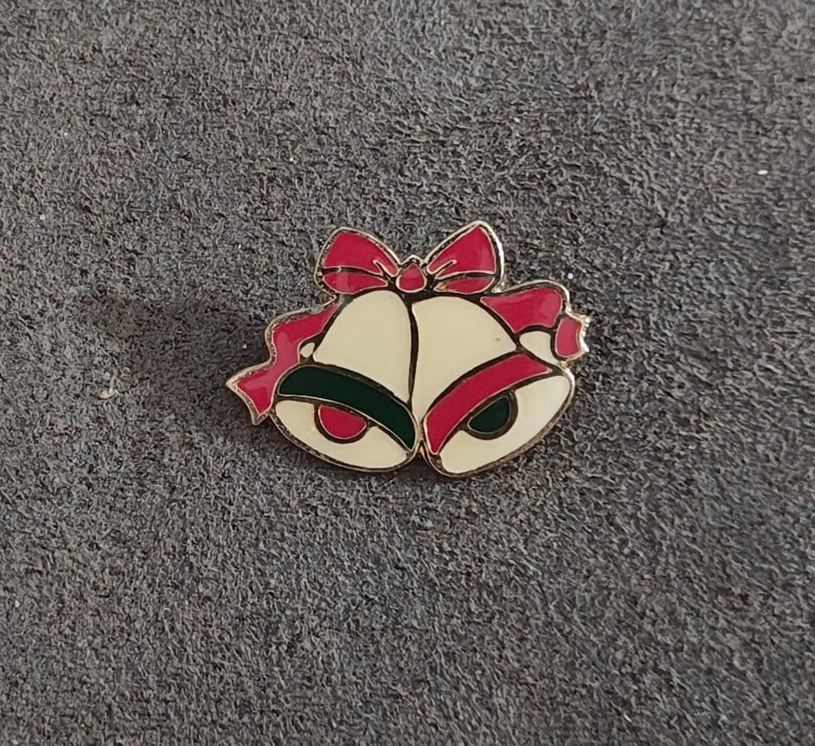 Gold tone enamel Christmas bells brooch with red ribbon bows and green enamel clappers, centered