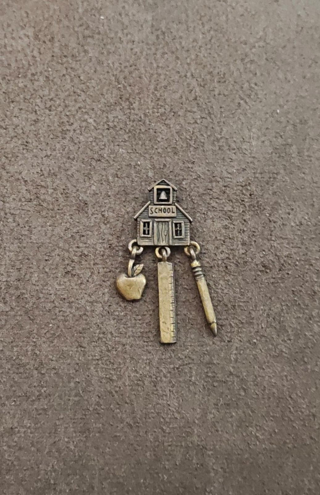 Brass schoolhouse teacher theme dangle pin with apple, ruler and pencil charms