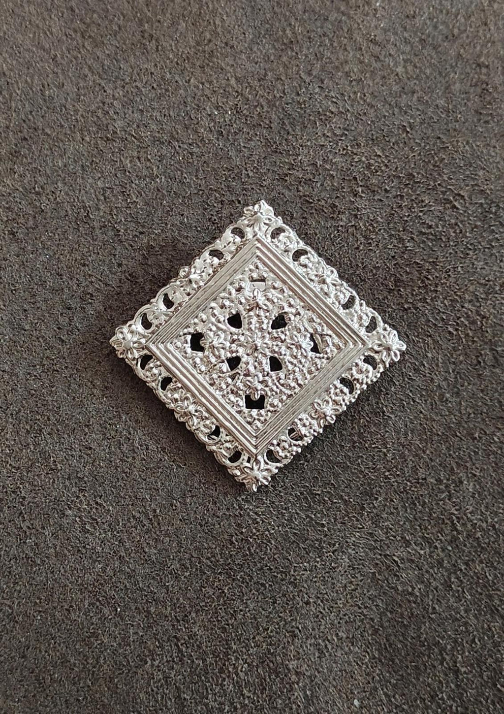 Silver-tone square filigree scarf clip featuring openwork floral design on smooth base