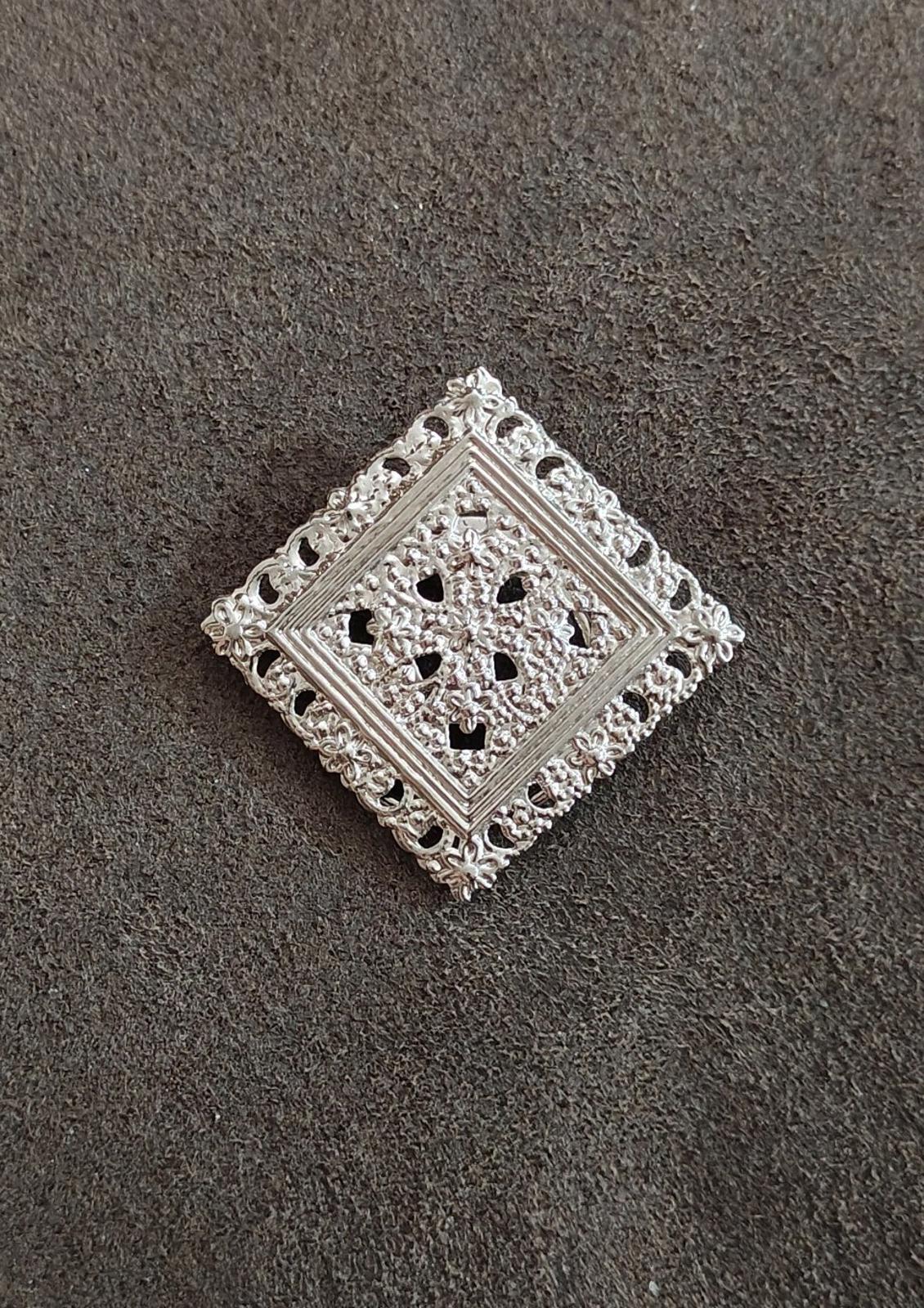 Silver-tone square filigree scarf clip featuring openwork floral design on smooth base
