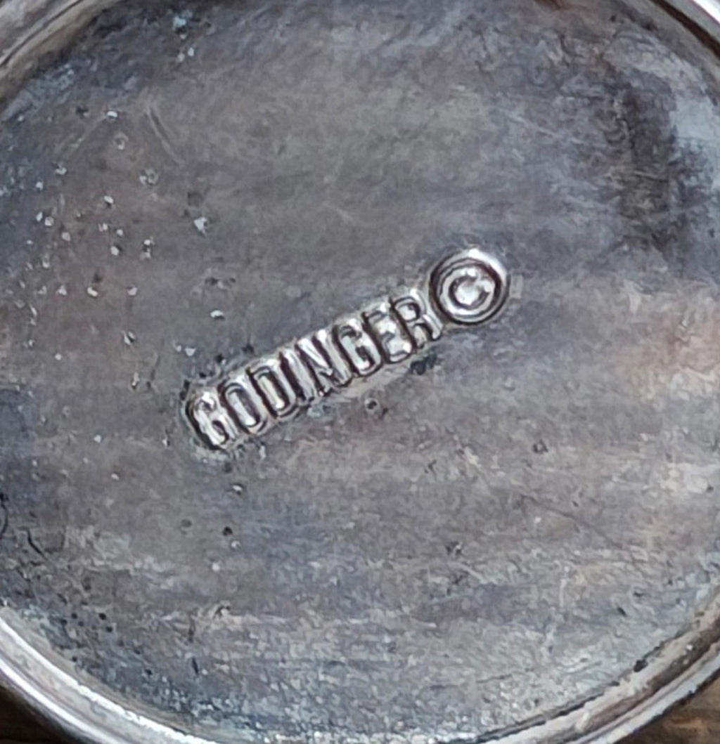GODINGER engraved mark on silverplated bucket base, close-up