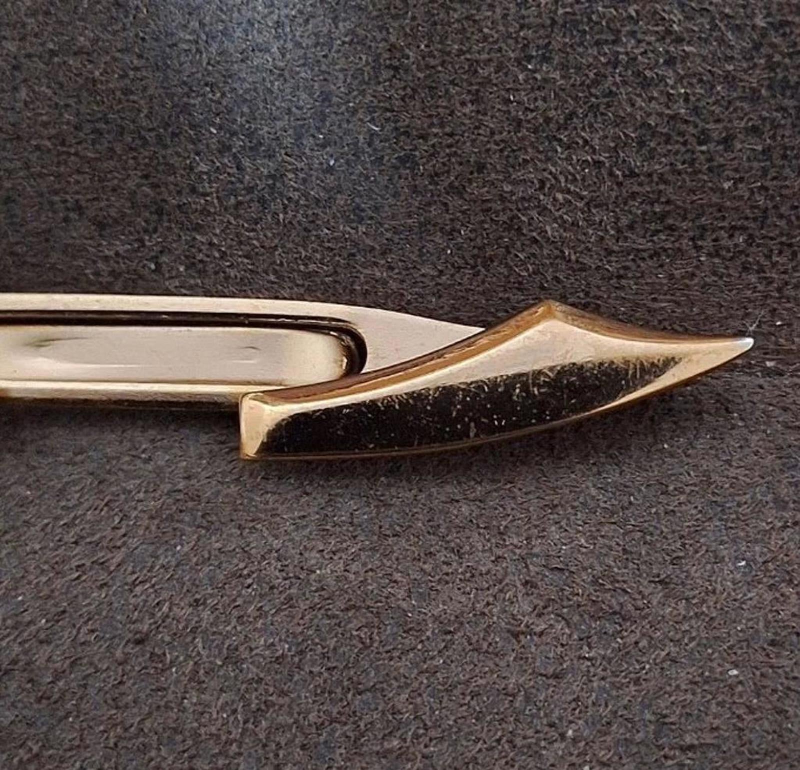 Gold pirate sword tie clip bar close-up of pointed blade end