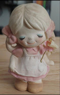 Vintage girl stoneware figurine, pink dress and bonnet, smiling with closed eyes