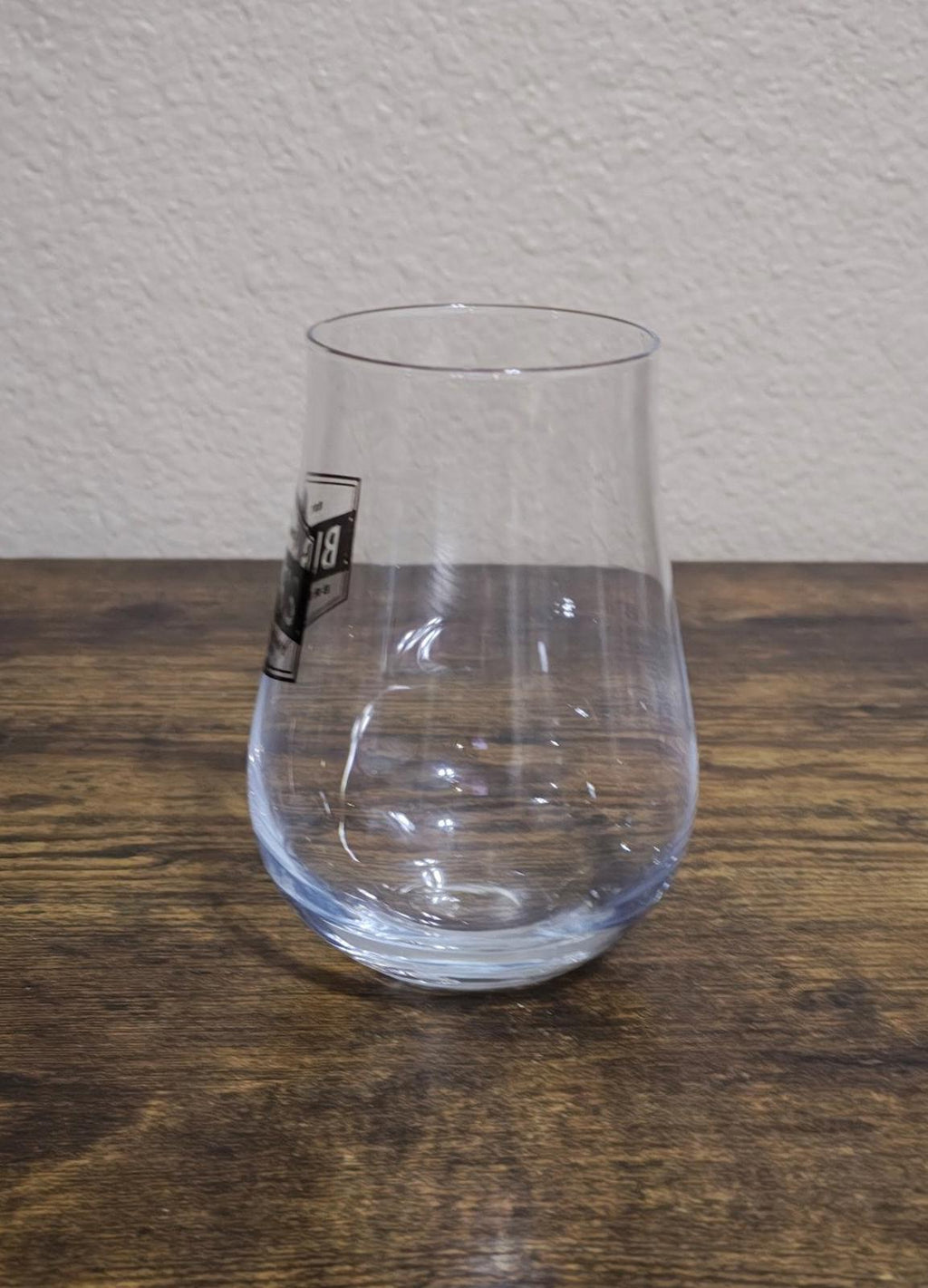Clear stemless wine/beer glass with partially visible Big Dog's Brewing Company logo