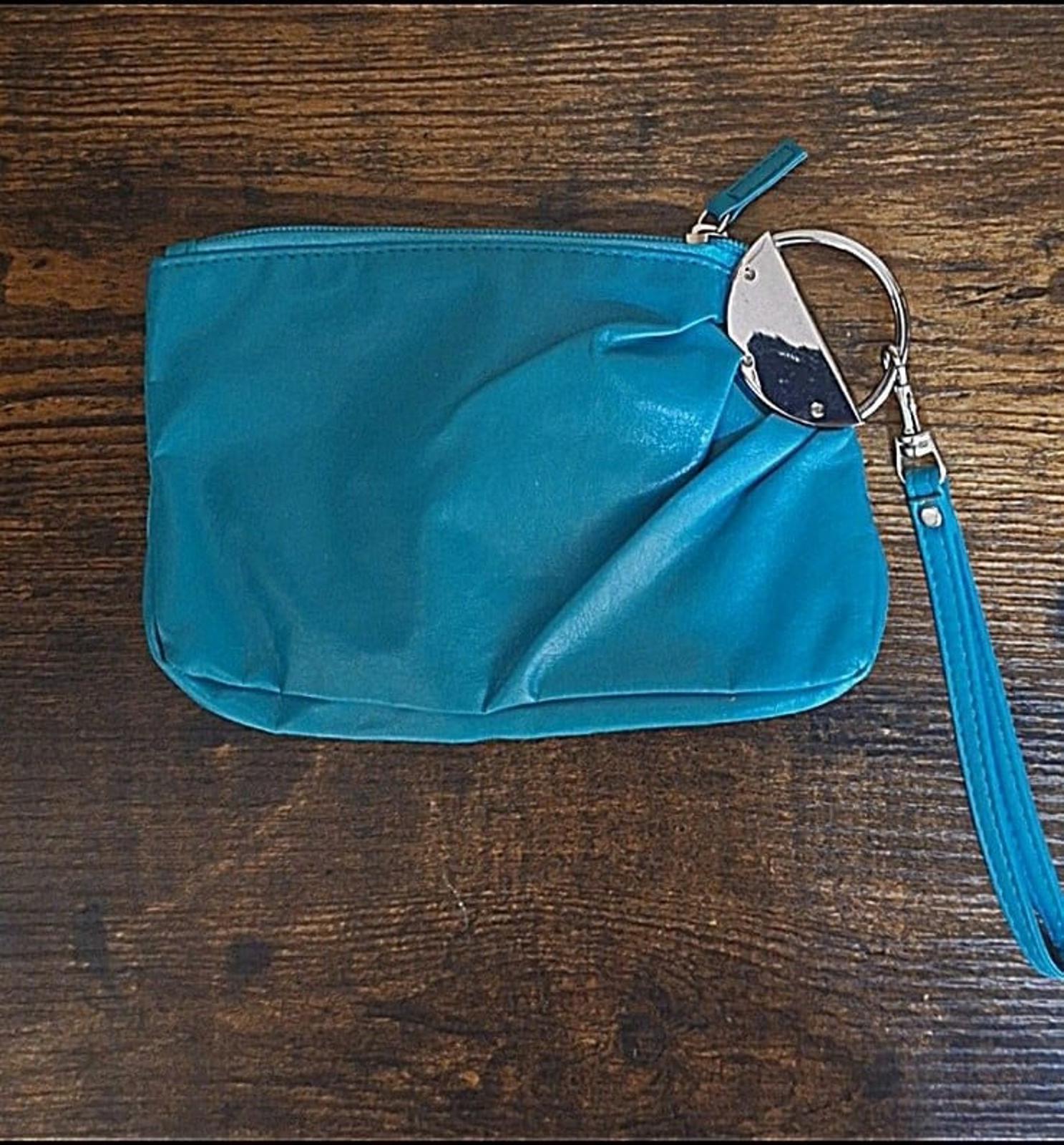 Teal PVC clutch purse with zipper closure and wrist strap, front view with hardware