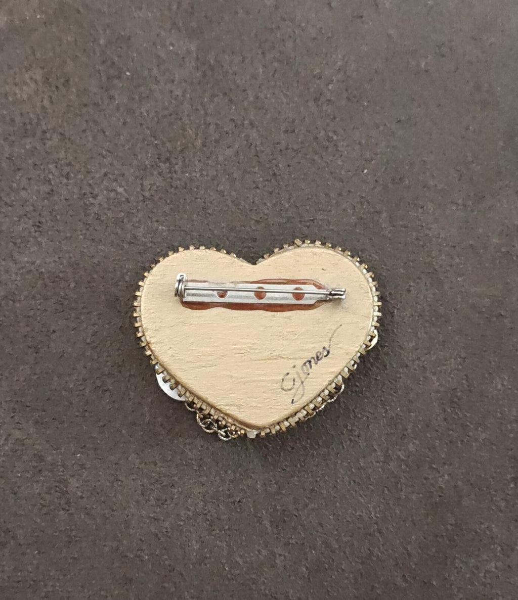 Heart-shaped gold tone brooch back with pin clasp and cursive maker text.
