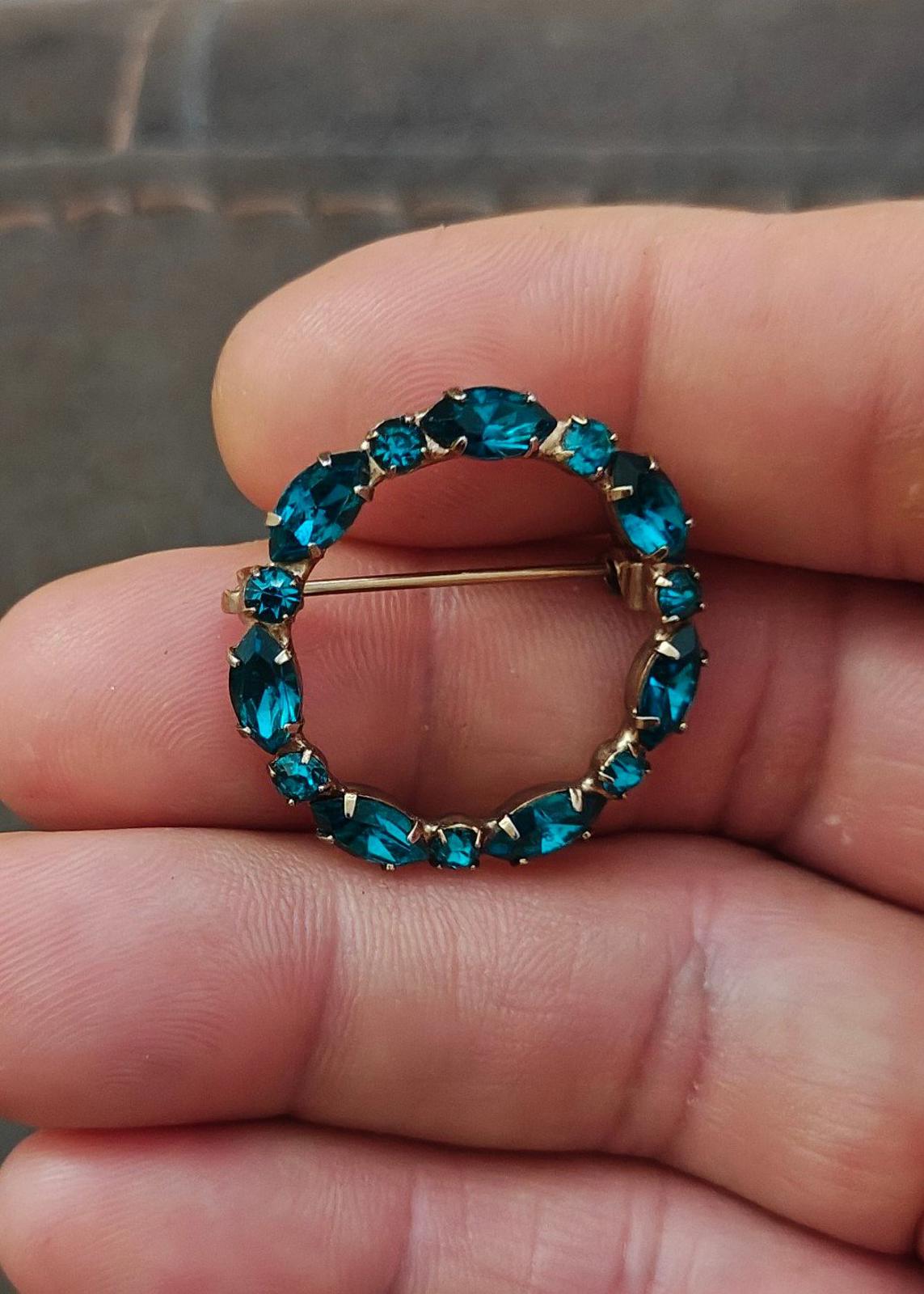 Aqua blue rhinestone circular brooch pin with gold-tone bar pin and raised stones