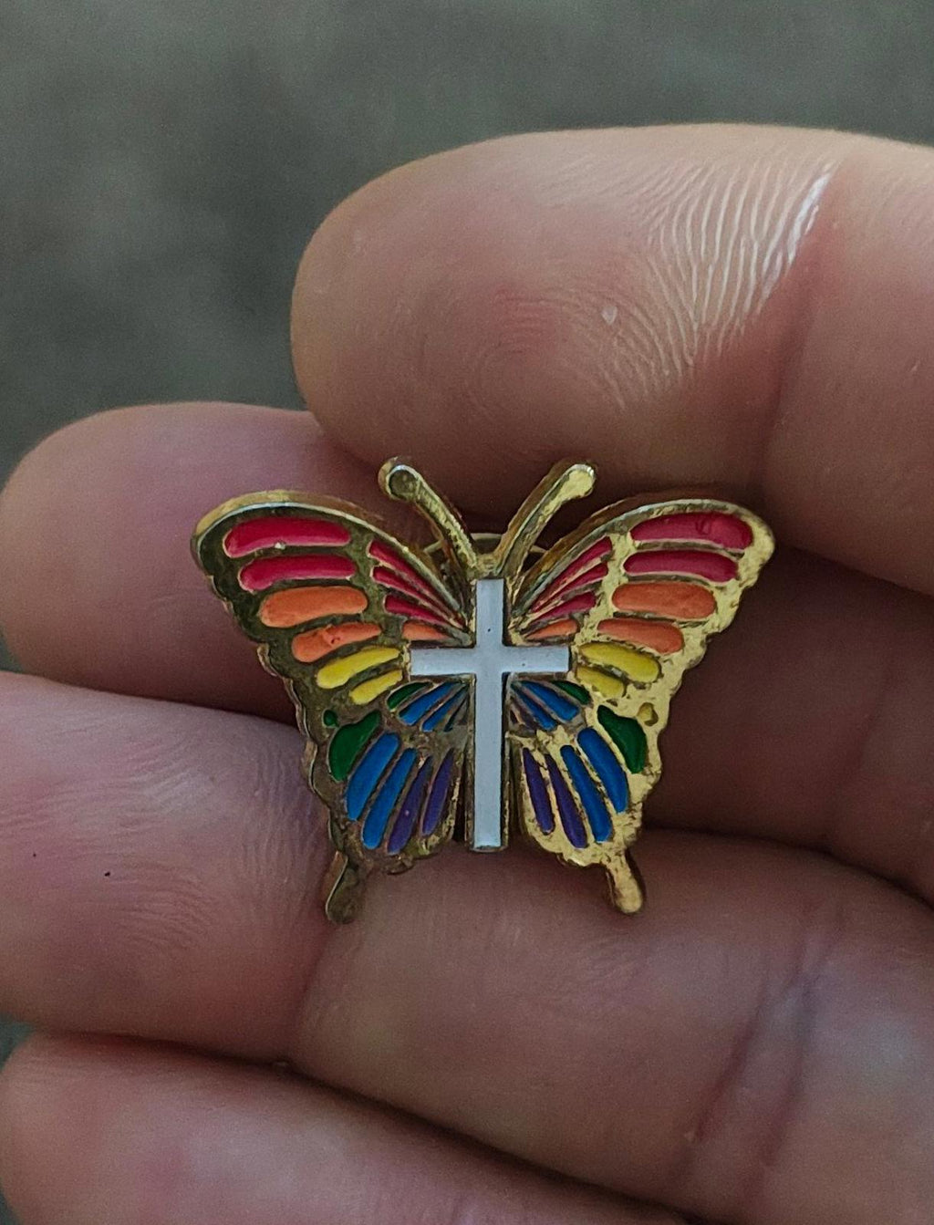 Rainbow butterfly enamel pin with white cross and multicolor wing enamel, gold tone