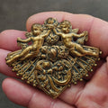 Gold-tone cherub double brooch with ornate filigree and fan-shaped skirt
