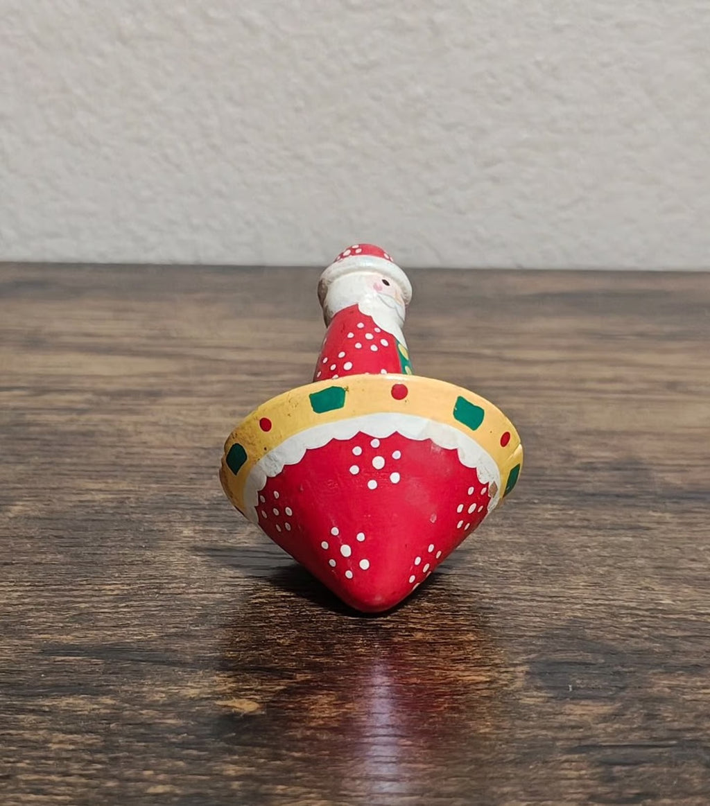 Hand-painted wooden Santa spinning top toy, red coat with white dots and green trim