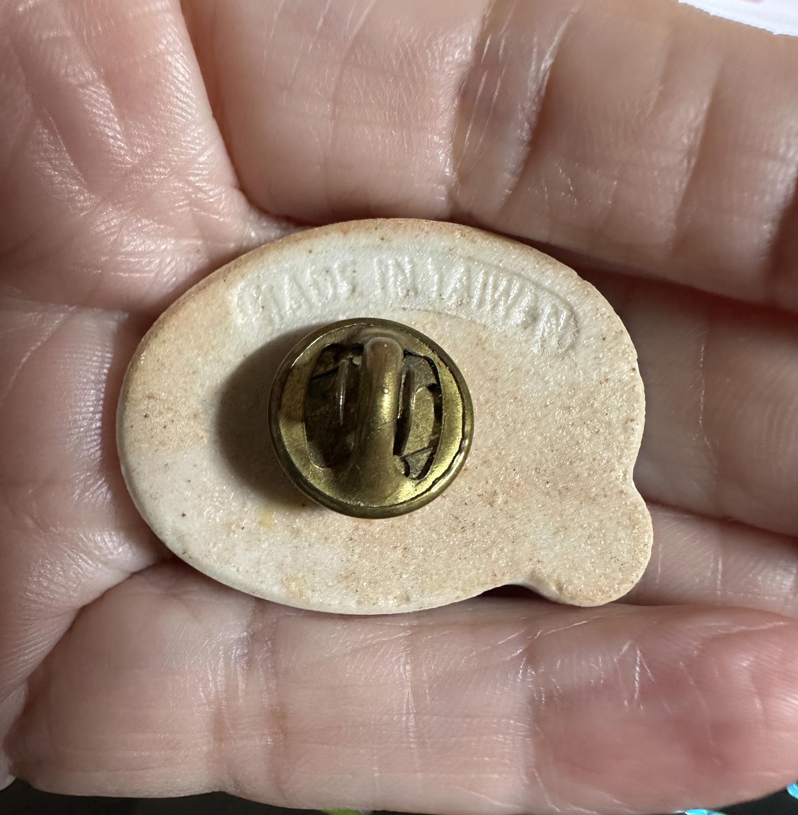 Jesus holiday lapel pin back on hand with gold-toned clasp and metal post