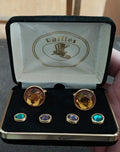 Gold-tone round cufflinks with amber faceted stones and blue/green shirt studs in box