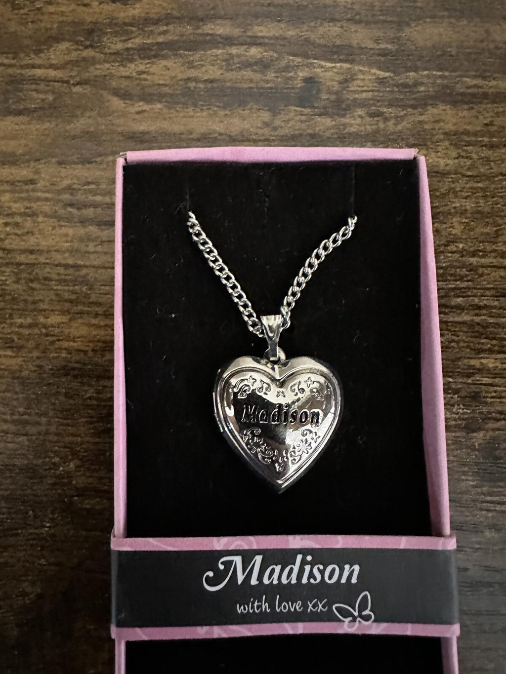 Silver-tone heart locket necklace in box, featuring engraved heart locket pendant