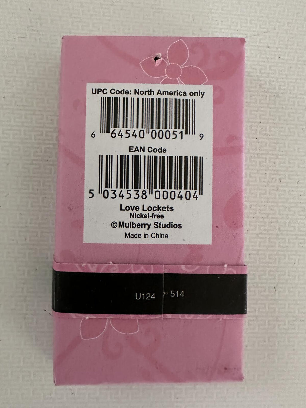 Love Lockets necklace box back label with barcode, pink and black packaging