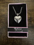 Silver-tone heart locket necklace with engraved “Rebecca” pendant and chain.