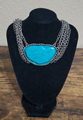 Silver Tone Multi Strand Chain Statement Necklace With a Faux Turquoise Stone