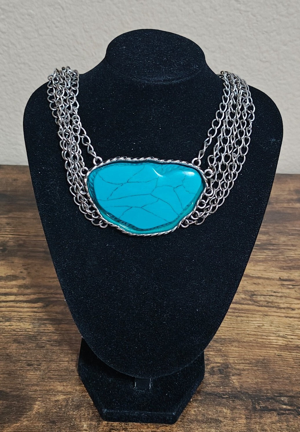 Silver Tone Multi Strand Chain Statement Necklace With a Faux Turquoise Stone