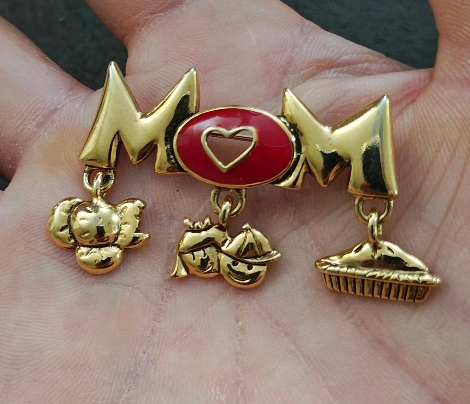 Gold-tone MOM brooch pin with red heart enamel center and three dangling charms