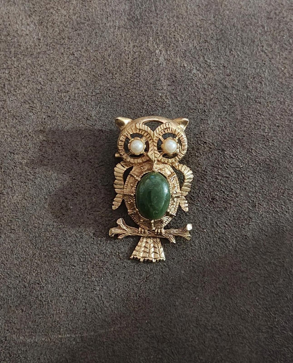Gold owl brooch with green oval cabochon belly and faux pearl eyes, full front view