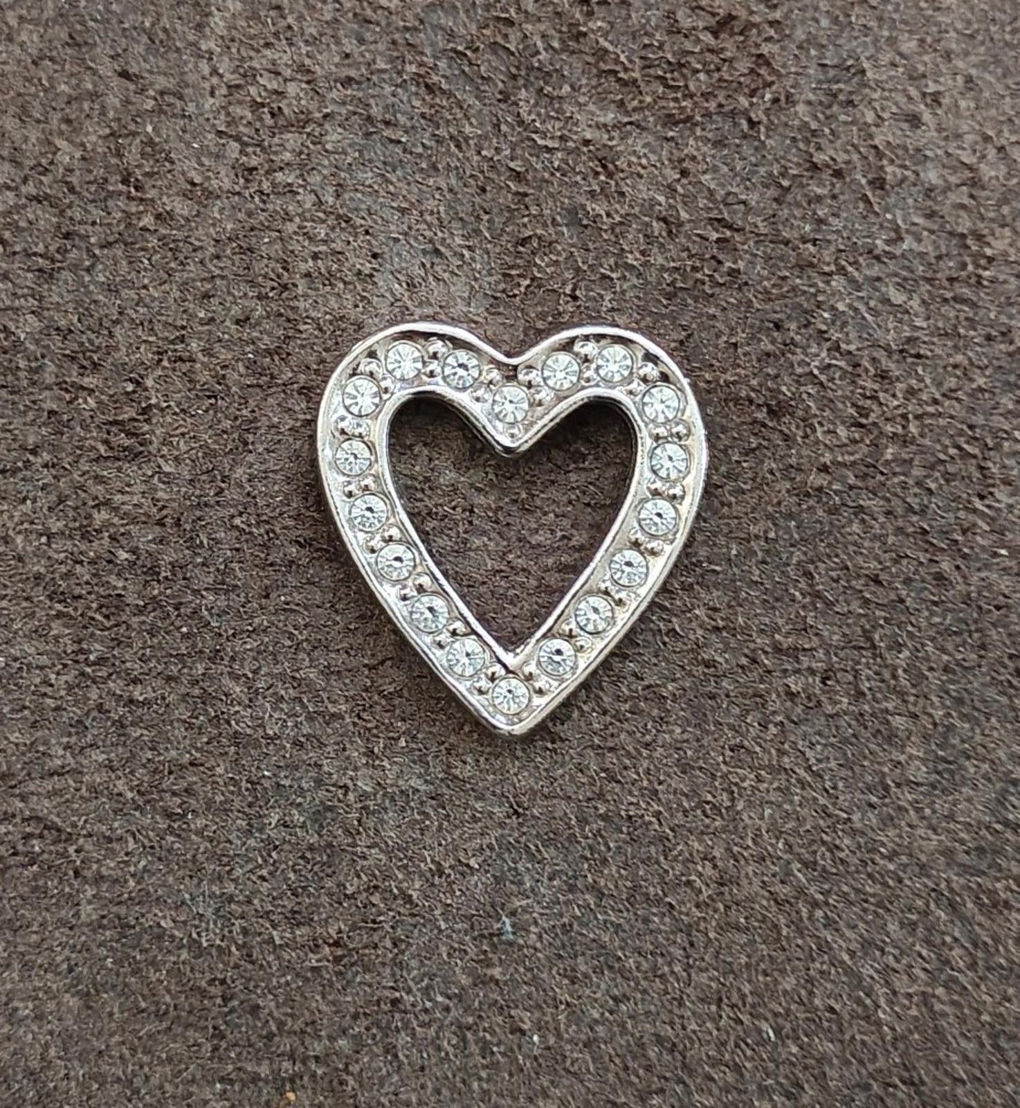 Silver tone open heart pin with rhinestone line border, full shape