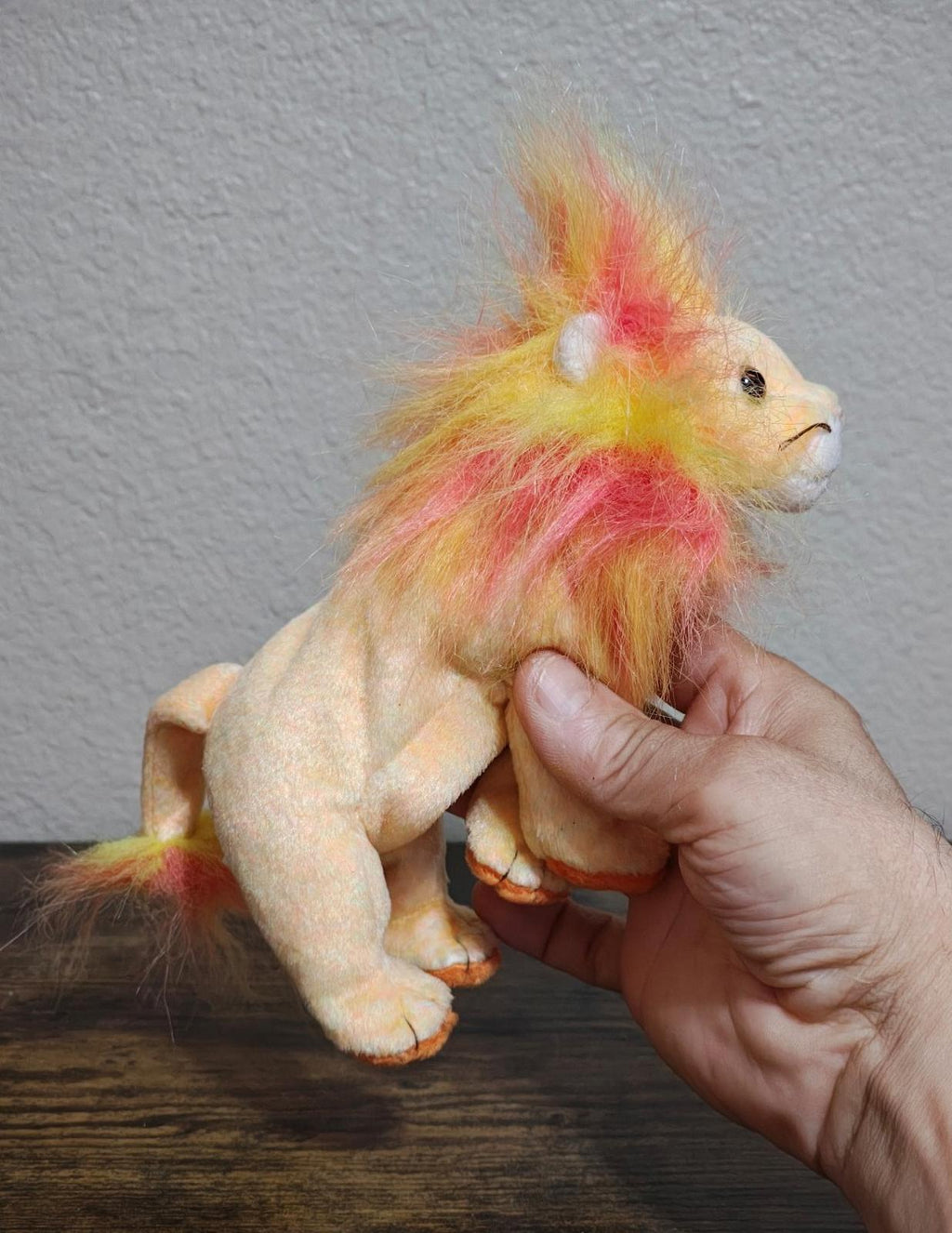 Rainbow-furred lion beanbag plush with side profile and front paws