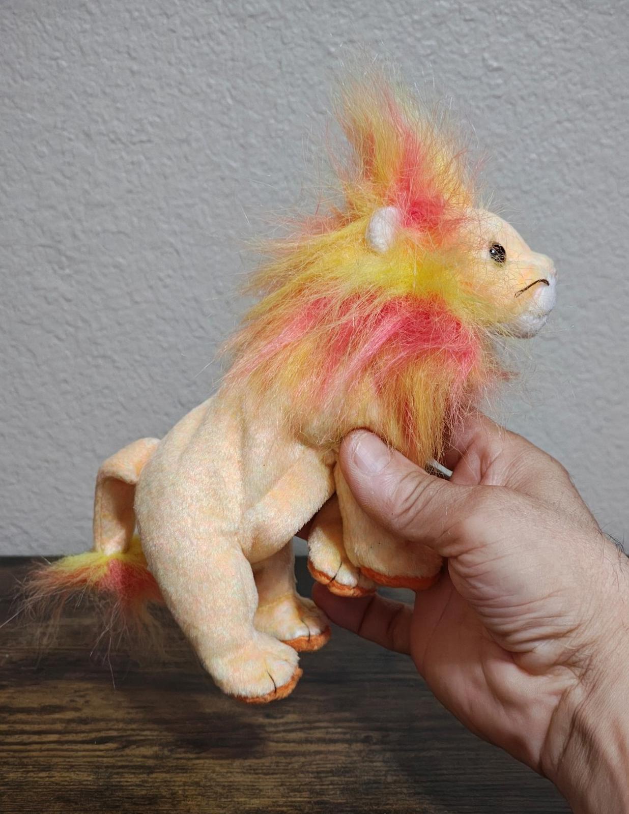 Rainbow-furred lion beanbag plush with side profile and front paws