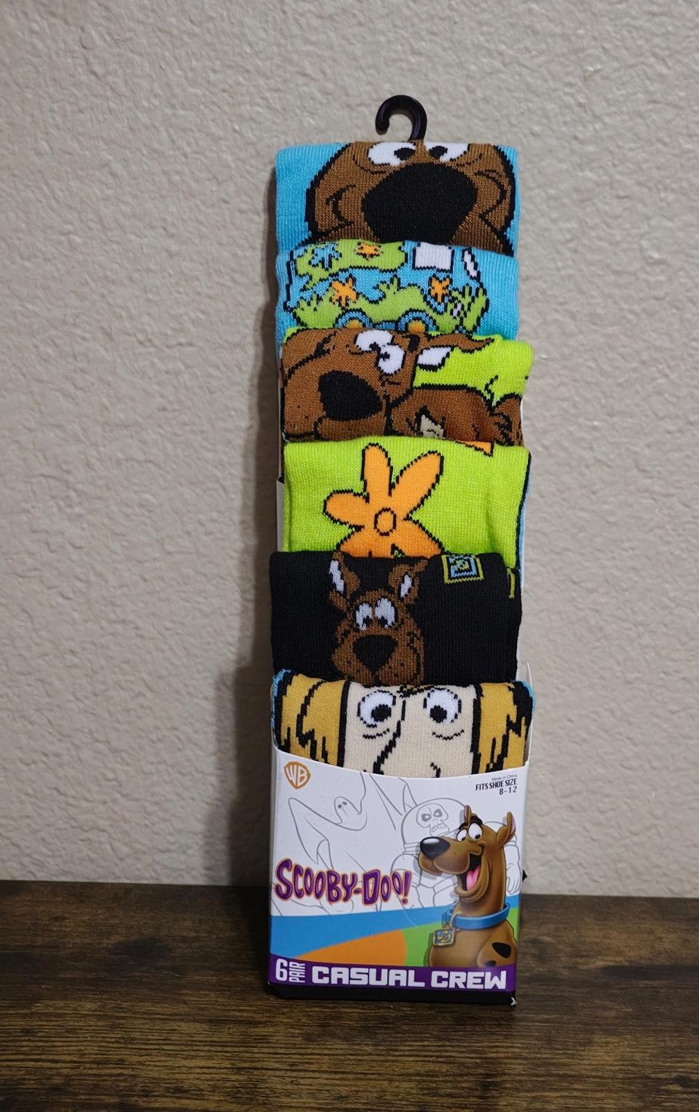 Colorful men's crew socks 6-pack showing character faces across multiple pairs.