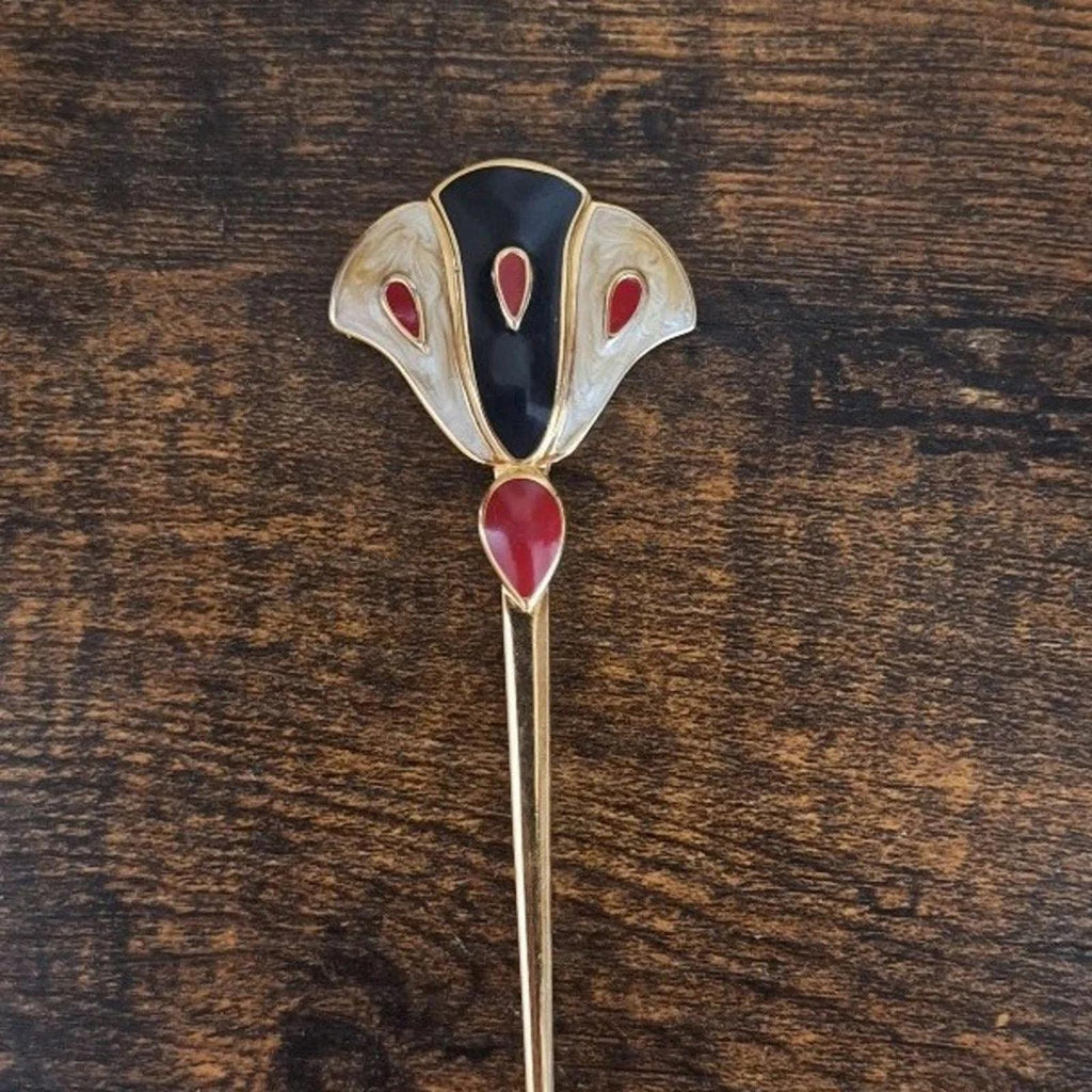 Gold-tone enamel flower pin brooch with dark blue center and red enamel petal accents