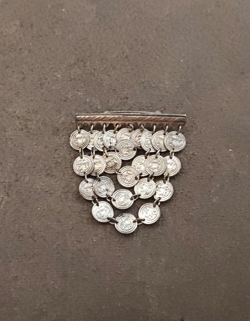Silver-tone coin dangle brooch showing round coin charms and rectangular top bar