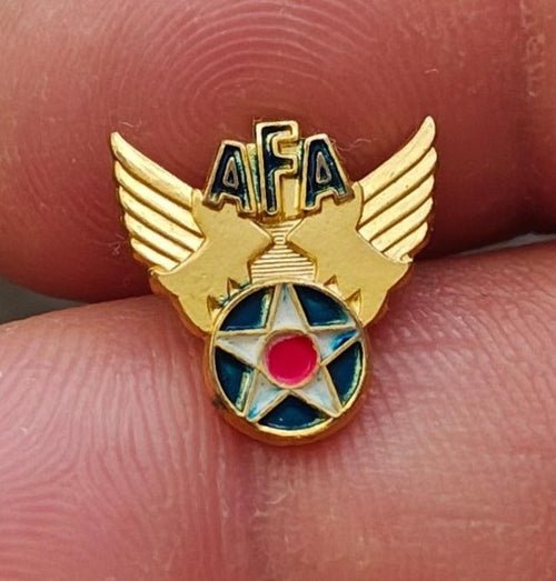 Gold tone AFA winged star enamel pin with blue ring and pink center, front view