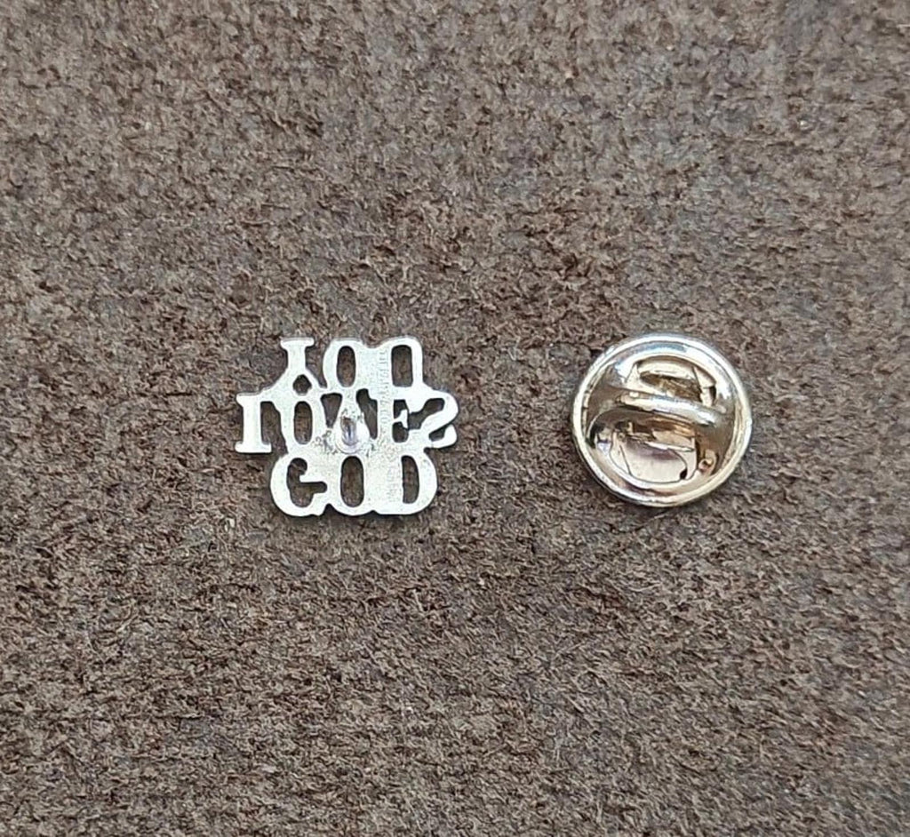 Sterling silver pin back showing safety pin clasp and maker details