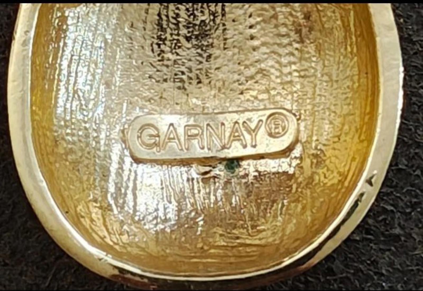 Stamped GARNAY logo on gold tone jewelry back inside curved pendant