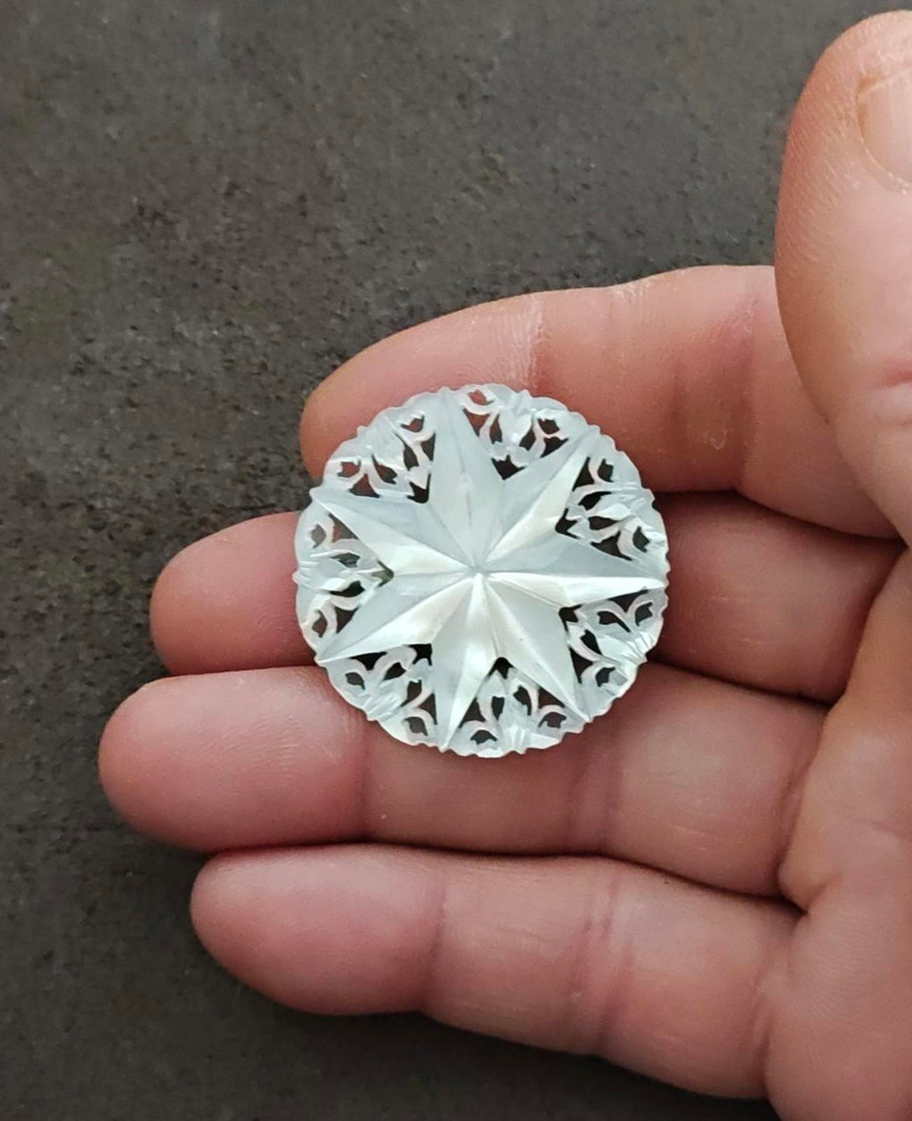 White carved mother-of-pearl Star of Bethlehem brooch, starburst center and cutout edges