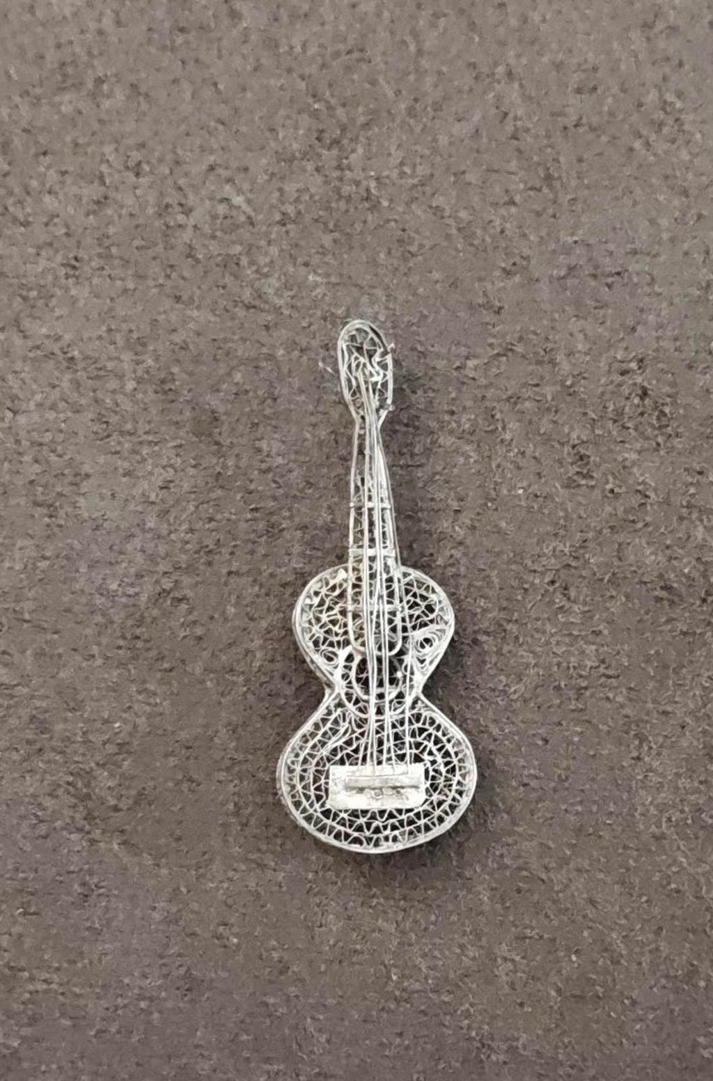 Sterling silver filigree guitar brooch with ornate lace-like wirework design
