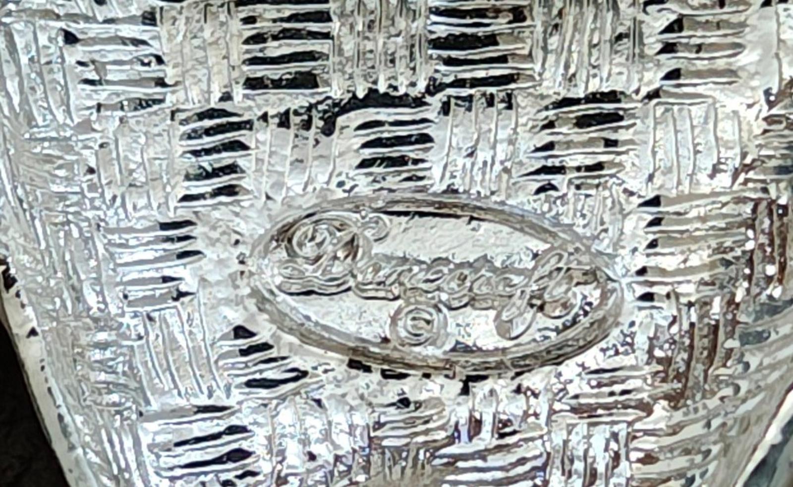 Silver-tone back of the tooth and toothbrush pin with ornate crest relief details.