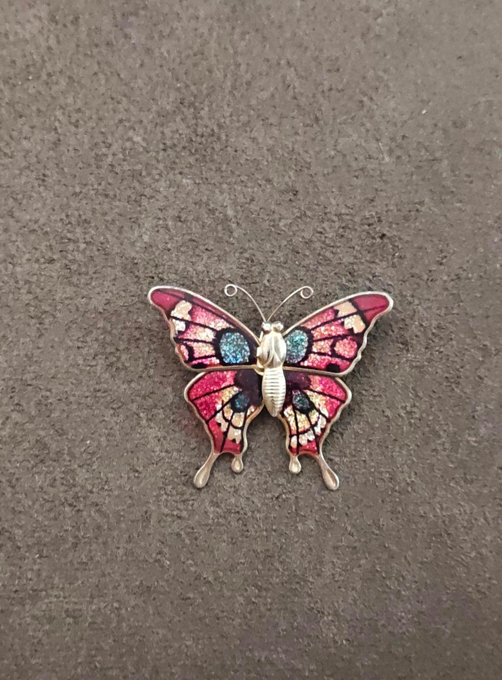 Butterfly enamel brooch, red wings with blue sparkle details, gold-tone metal frame