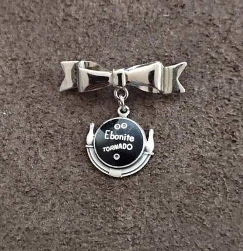 Silver tone bow bar pin with Ebonite Tornado round dangle