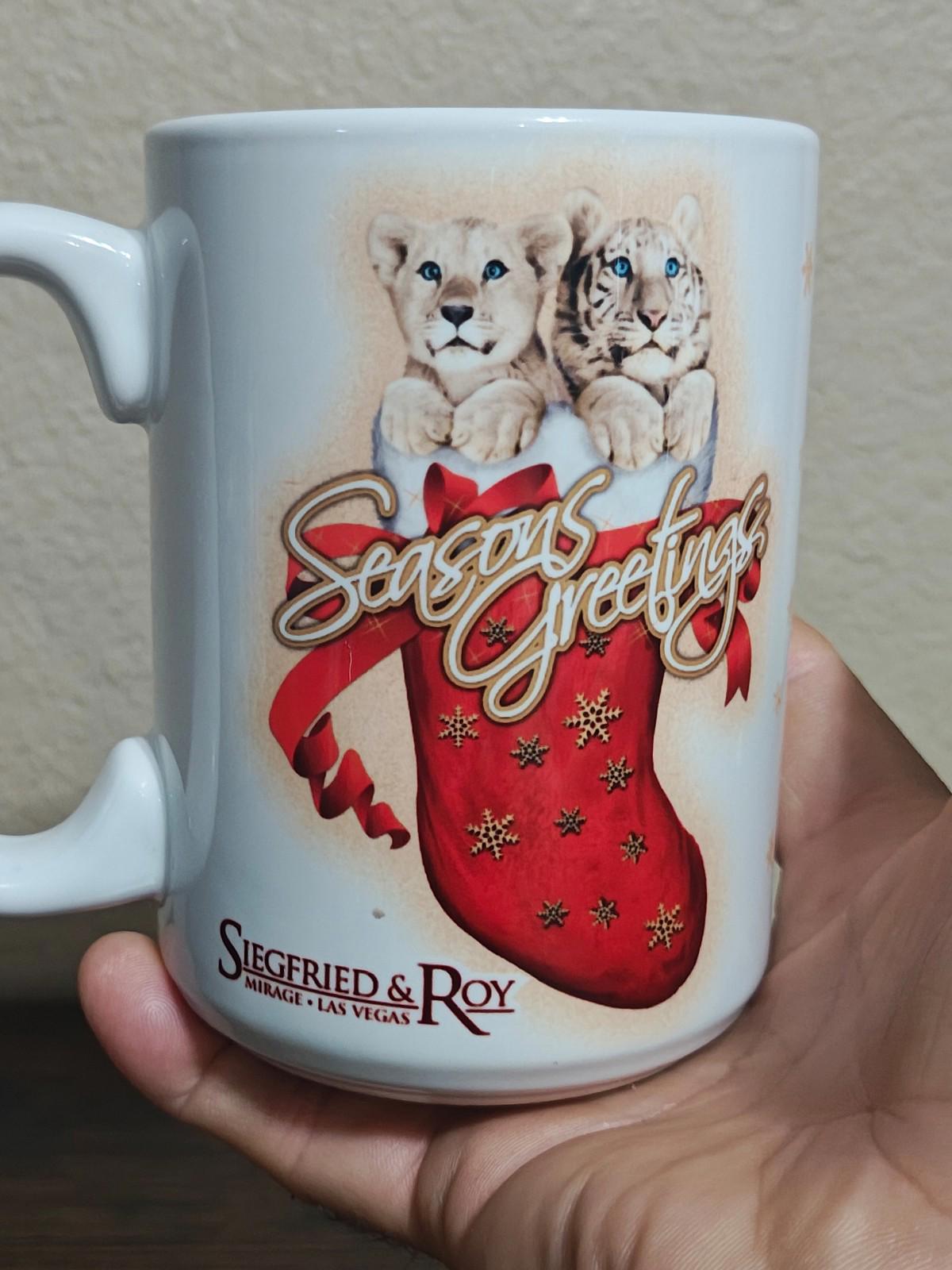 White porcelain mug front view with two big cats and red “Seasons Greetings” stocking print